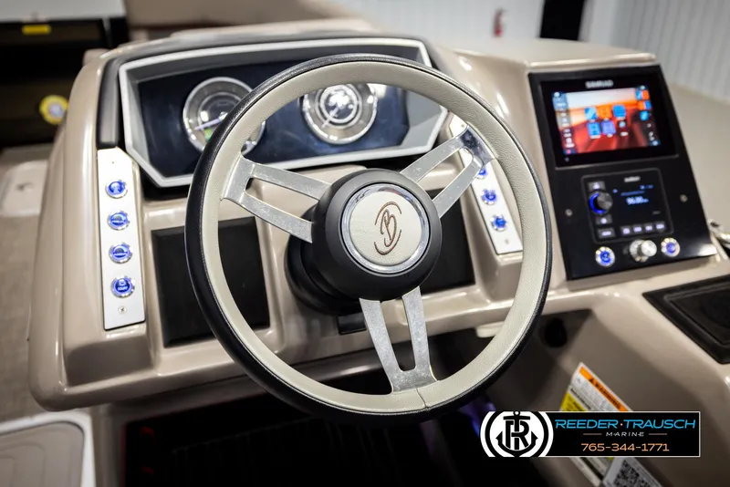 Slide: The Image of Steering wheel and dashboard of 2023 Barletta 21 UC boat, featuring modern controls. - 35