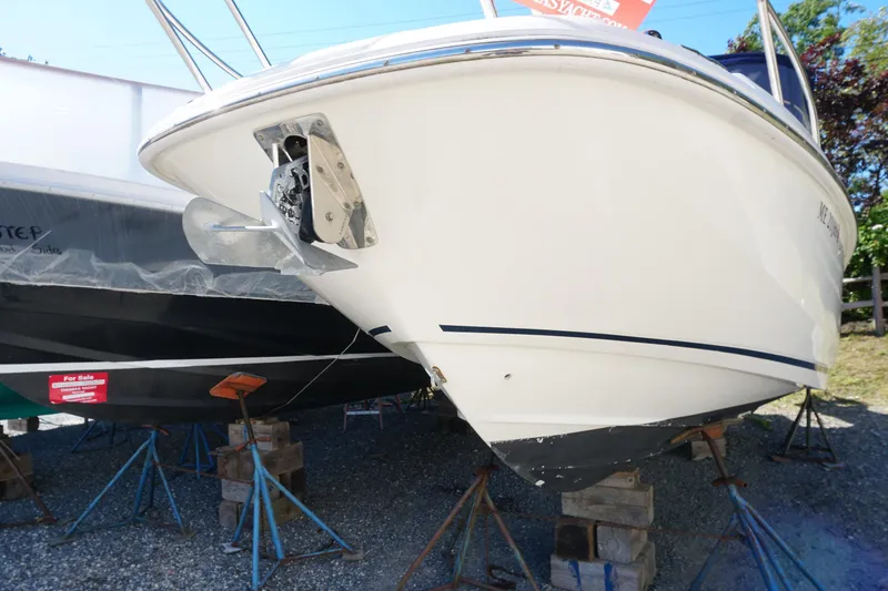 Slide: The Image of 2018 Boston Whaler 230 Vantage boat on stands, displayed outdoors. - 11