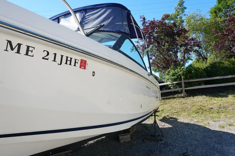 Slide: The Image of 2018 Boston Whaler 230 Vantage boat on stands, side view with registration number. - 12