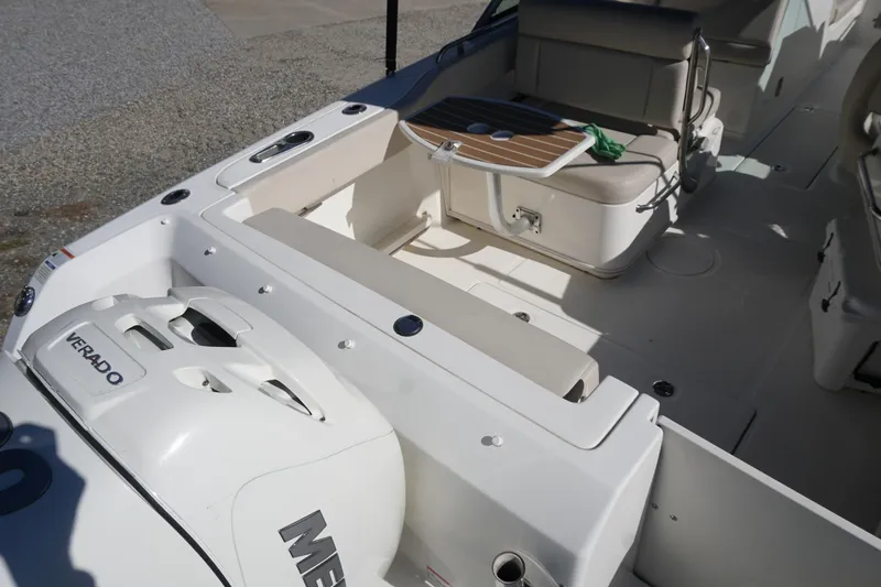 Slide: The Image of 2018 Boston Whaler 230 Vantage boat interior with seating and Mercury Verado engine. - 16