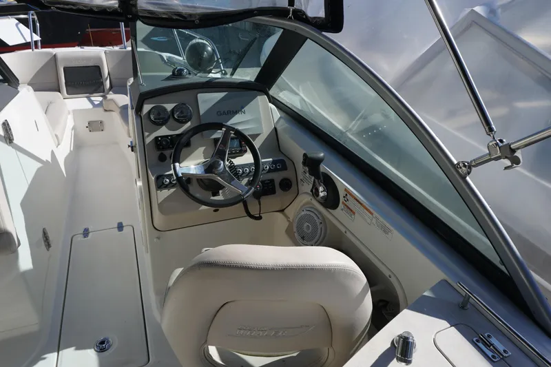 Slide: The Image of 2018 Boston Whaler 230 Vantage boat cockpit with steering wheel and Garmin navigation system. - 18