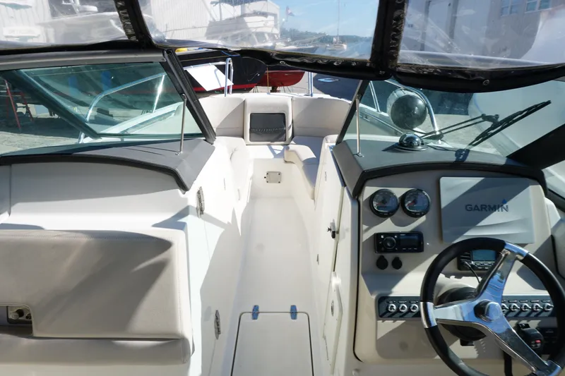 Slide: The Image of 2018 Boston Whaler 230 Vantage boat interior with Garmin navigation system and steering wheel. - 19