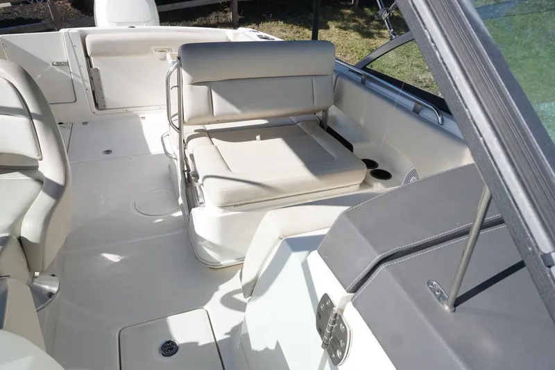 Slide: The Image of 2018 Boston Whaler 230 Vantage boat interior with white seating and open deck layout. - 22