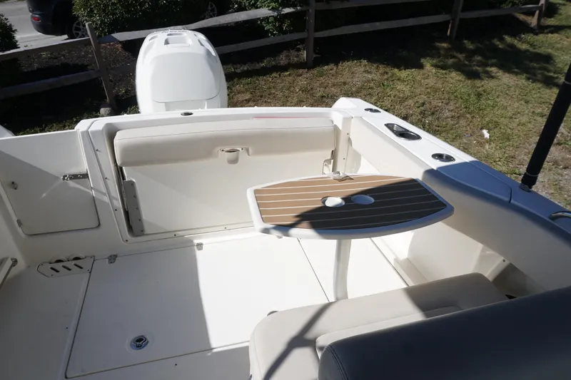 Slide: The Image of 2018 Boston Whaler 230 Vantage boat interior with seating and table. - 24