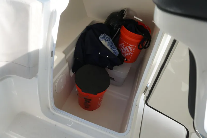 Slide: The Image of Storage compartment in a 2018 Boston Whaler 230 Vantage with buckets and gear. - 25