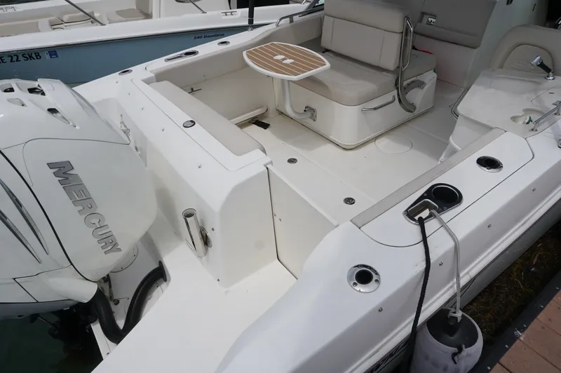 Slide: The Image of 2018 Boston Whaler 230 Vantage boat interior with seating and Mercury engine. - 4