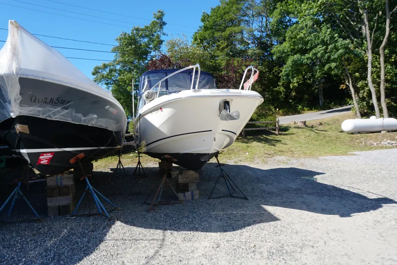 Slide: The Image of 2018 Boston Whaler 230 Vantage boat on stands, outdoors, sunny day. - 9