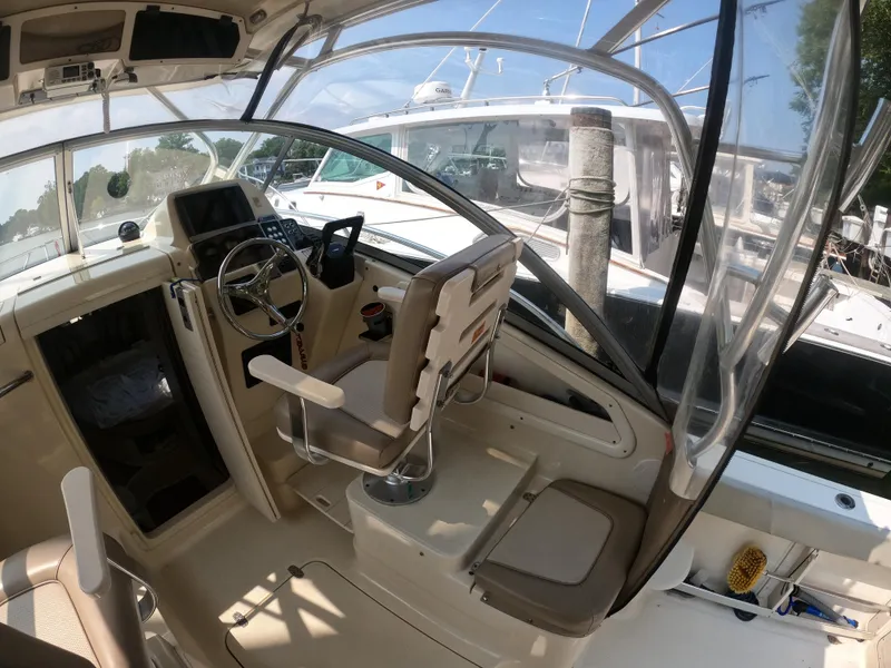Slide: The Image of 2010 Scout 262 Abaco boat interior with steering wheel and seating. - 10