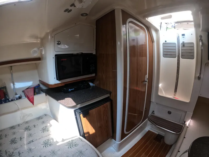 Slide: The Image of 2010 Scout 262 Abaco cabin interior with kitchenette and wooden accents. - 13