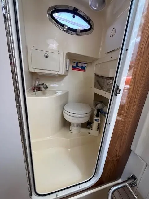 Slide: The Image of 2010 Scout 262 Abaco boat bathroom with sink, toilet, and storage. - 16