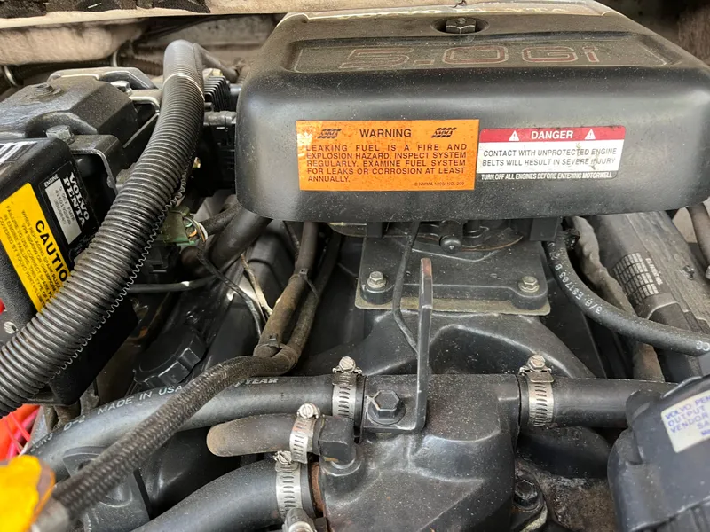 Slide: The Image of Engine compartment of a 1999 Chaparral 1930 SS with warning labels and visible components. - 11