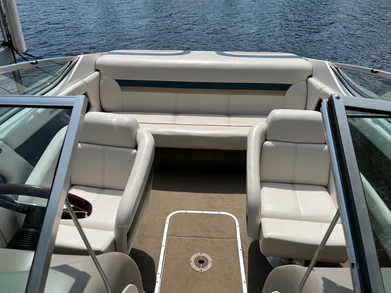 Slide: The Image of Interior of a 1999 Chaparral 1930 SS boat with white seating and open water view. - 5