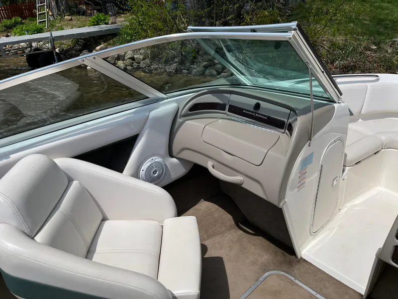 Slide: The Image of Interior of a 1999 Chaparral 1930 SS boat with white seating and dashboard. - 6
