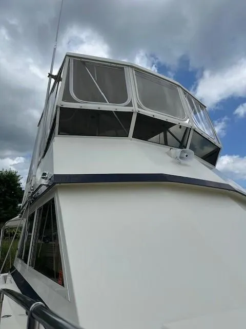 Slide: The Image of 1986 Viking 35 Convertible boat under cloudy sky. - 10