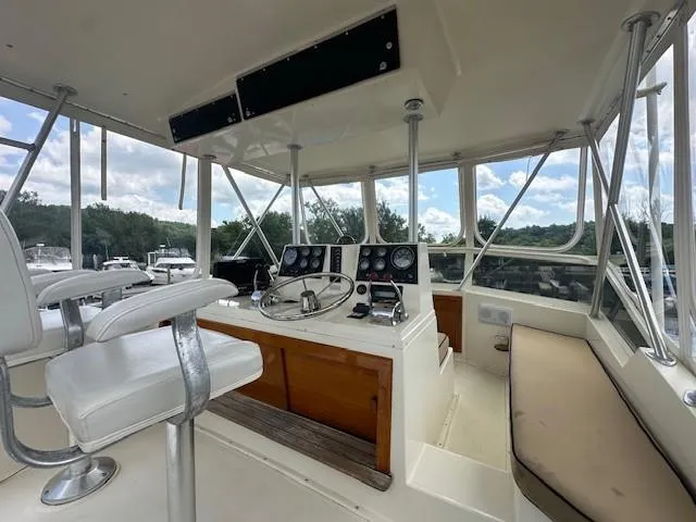 Slide: The Image of 1986 Viking 35 Convertible boat interior with helm, seating, and control panel. - 13