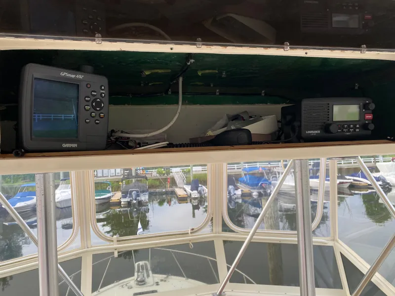 Slide: The Image of 1986 Viking 35 Convertible boat cockpit with Garmin GPS and Lowrance radio equipment. - 17