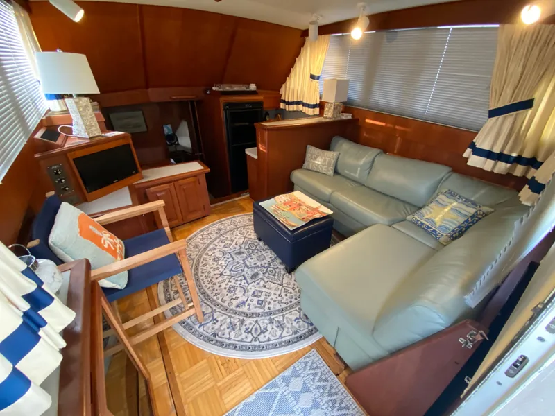 Slide: The Image of Interior of 1986 Viking 35 Convertible yacht with cozy seating and nautical decor. - 19