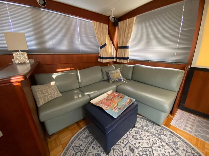 Slide: The Image of Cozy interior of 1986 Viking 35 Convertible with sectional sofa and nautical decor. - 20