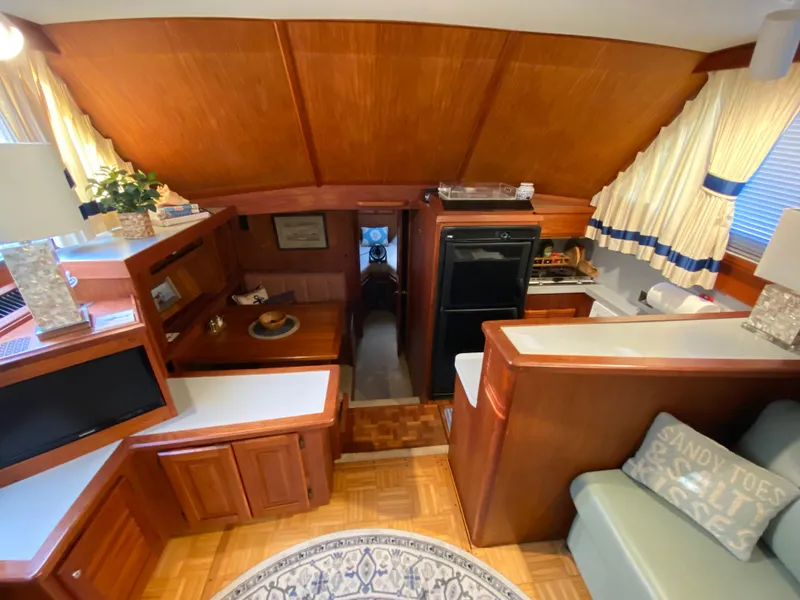 Slide: The Image of Interior of a 1986 Viking 35 Convertible yacht with wood paneling and cozy furnishings. - 23