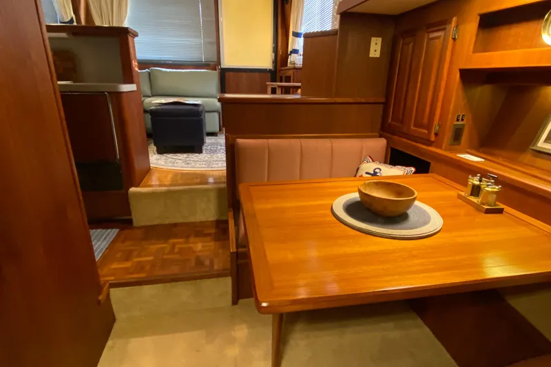 Slide: The Image of Interior of a 1986 Viking 35 Convertible yacht with wooden dining area and cozy seating. - 26