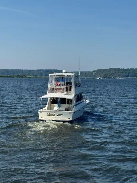 Slide: The Image of 1986 Viking 35 Convertible boat named "Monomoy" cruising on a sunny day. - 3