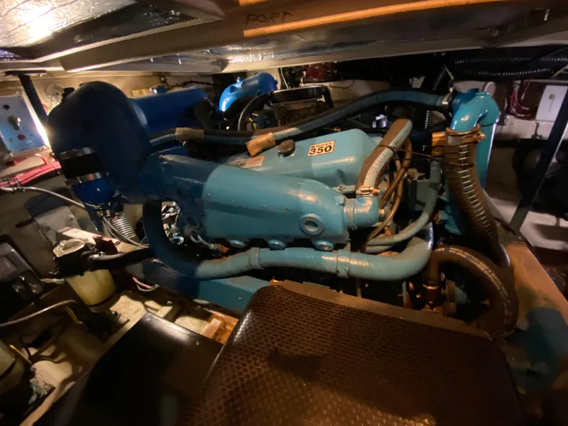 Slide: The Image of Engine room of a 1986 Viking 35 Convertible boat, featuring a blue marine engine. - 32
