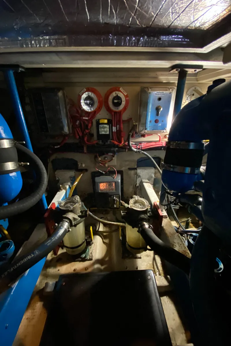 Slide: The Image of Engine room of a 1986 Viking 35 Convertible boat, showcasing mechanical components and wiring. - 34