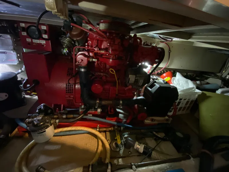 Slide: The Image of Engine room of 1986 Viking 35 Convertible boat with red machinery and various components. - 35