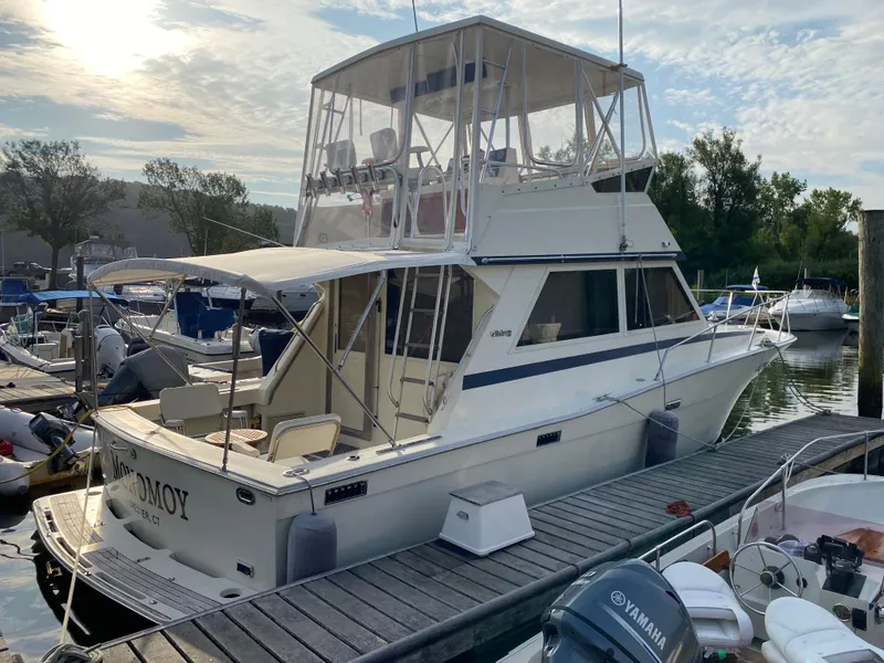 Slide: The Image of 1986 Viking 35 Convertible yacht docked at marina, featuring flybridge and spacious deck. - 6