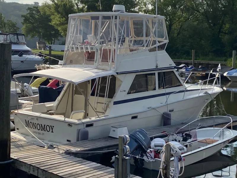 Slide: The Image of 1986 Viking 35 Convertible boat docked, featuring enclosed flybridge and classic design. - 8