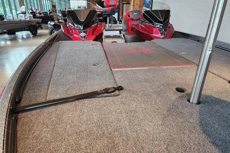Slide: The Image of 2025 Ranger Z521R Cup-Equipped boat interior with carpeted deck and seating. - 2