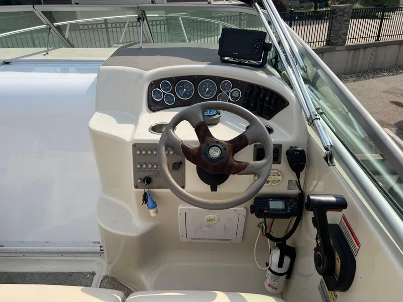 Slide: The Image of Crownline 242 CR 2000 boat dashboard with steering wheel and control panel. - 10