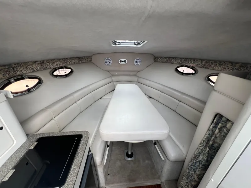 Slide: The Image of Interior of 2000 Crownline 242 CR boat with seating and table arrangement. - 15