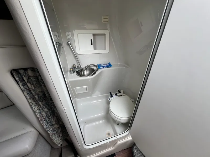Slide: The Image of Compact bathroom in 2000 Crownline 242 CR boat with sink and toilet. - 17