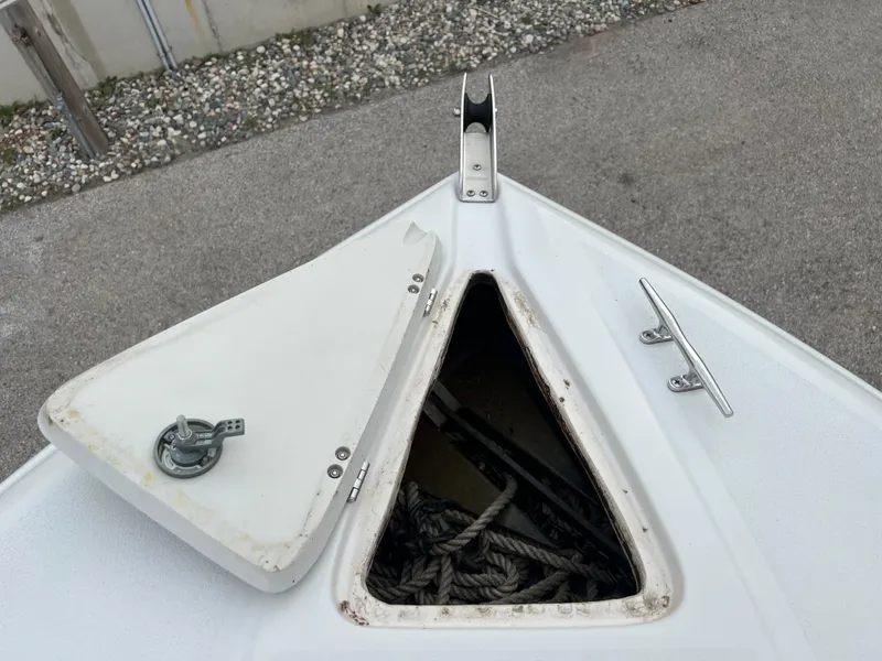 Slide: The Image of Open anchor locker on 2000 Crownline 242 CR boat, showing ropes inside. - 19