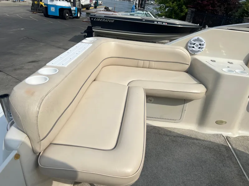 Slide: The Image of Crownline 242 CR 2000 boat interior with beige seating and cup holders. - 7