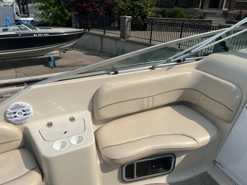 Slide: The Image of Crownline 242 CR 2000 boat interior with beige seating and cup holders. - 8