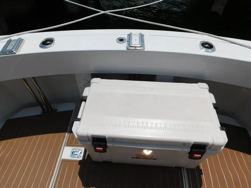 Slide: The Image of 1999 Mainship Pilot 30 deck with Pelican cooler, featuring teak flooring and stainless steel fittings. - 11