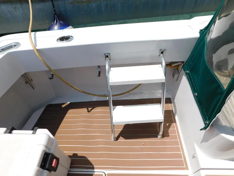 Slide: The Image of 1999 Mainship Pilot 30 boat deck with ladder and storage box. - 12