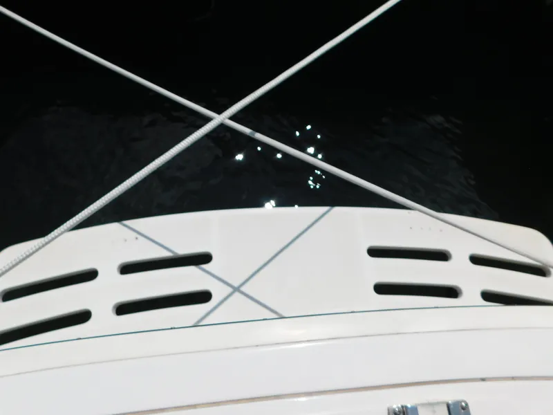 Slide: The Image of 1999 Mainship Pilot 30 boat deck with ropes and water reflection. - 13