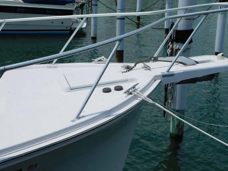 Slide: The Image of Bow of a 1999 Mainship Pilot 30 docked at a marina. - 2