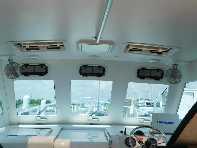 Slide: The Image of Interior view of 1999 Mainship Pilot 30 boat cockpit with windows and navigation equipment. - 29