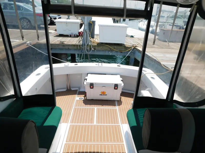 Slide: The Image of 1999 Mainship Pilot 30 boat interior with Pelican cooler on deck. - 32