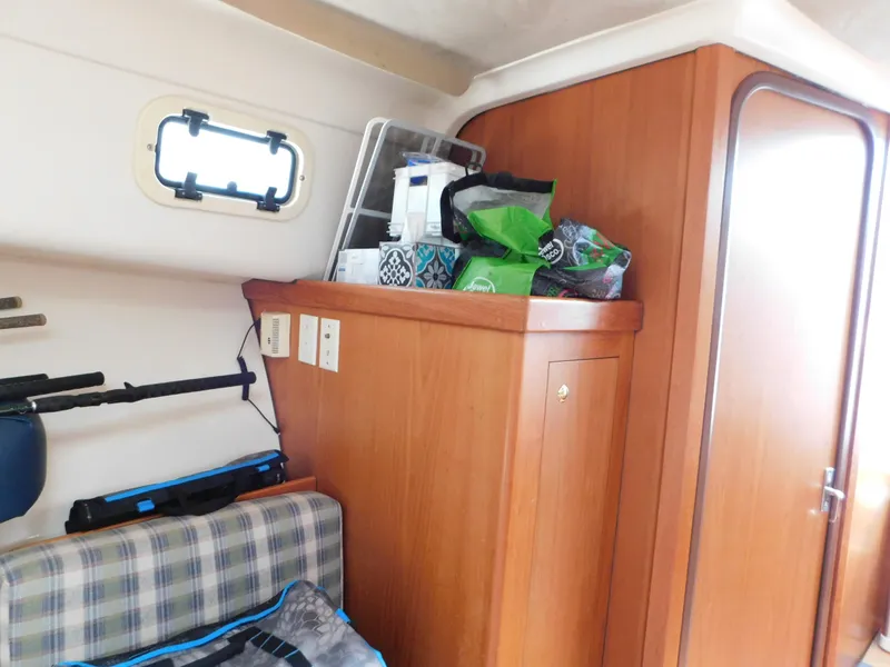 Slide: The Image of Interior of 1999 Mainship Pilot 30 boat with wooden cabinetry and storage area. - 41