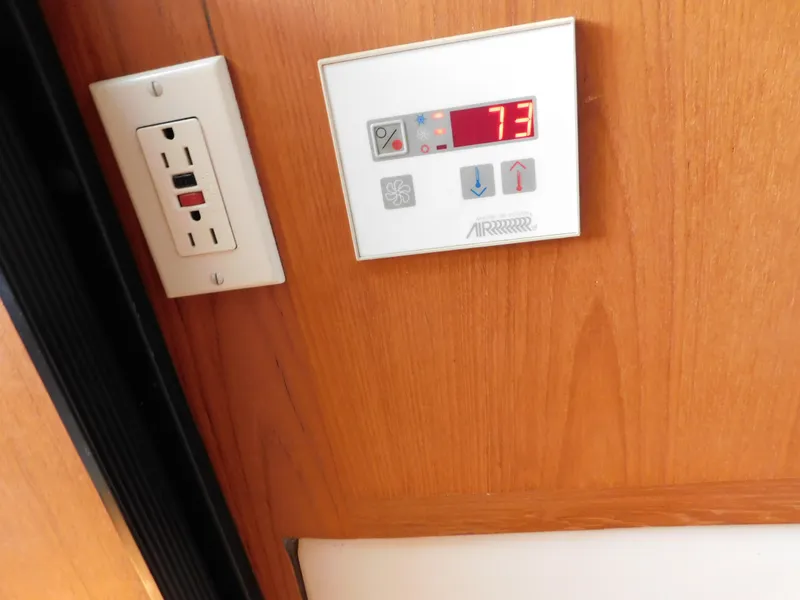 Slide: The Image of Thermostat and outlet on Mainship Pilot 30 boat, 1999 model, displaying 73 degrees. - 45
