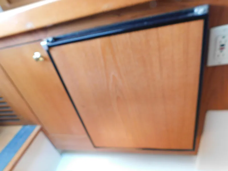 Slide: The Image of Wooden cabinet door inside 1999 Mainship Pilot 30 boat interior. - 46