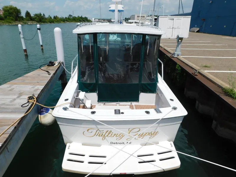 Slide: The Image of 1999 Mainship Pilot 30 docked, rear view with "Trifling Gypsy" name, Detroit, MI. - 5