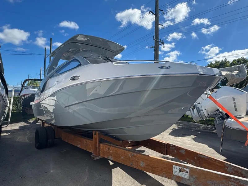 Slide: The Image of 2025 NX Boats NX280 XTREME on trailer under blue sky. - 3