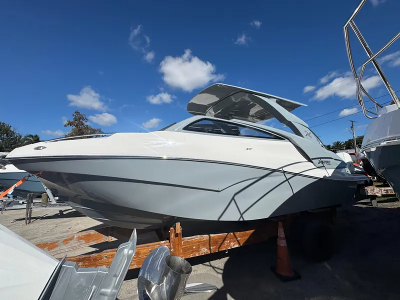 Slide: The Image of 2025 NX Boats NX280 XTREME on display under a clear blue sky. - 4