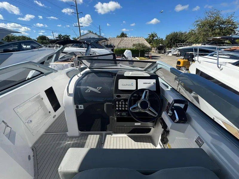 Slide: The Image of 2025 NX Boats NX280 XTREME cockpit with modern controls and Garmin navigation system. - 5